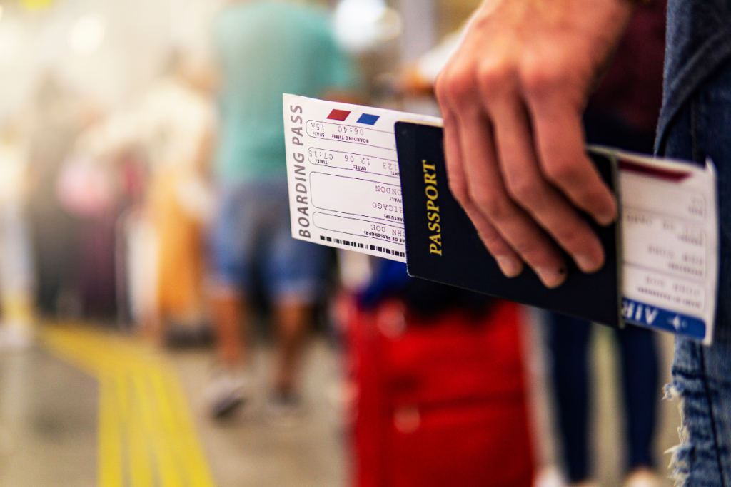 Man holding a boarding pass and passport